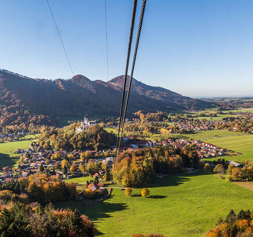 Herbstliche Berglandschaft mit Seilbahn und buntem Laub in Hohenaschau