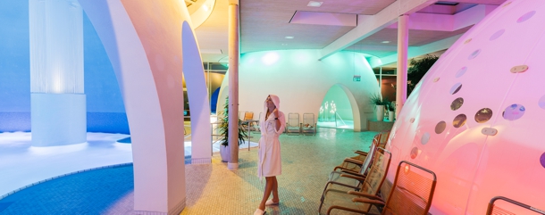 Therme Bad Aibling Beleuchtung 610 Therme Bad Aibling, Frau im Bademantel zwischen den Wasserbecken.